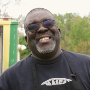 Richard Rodney serving Jamaican food at the Reggae Fest in Fair Meadows!